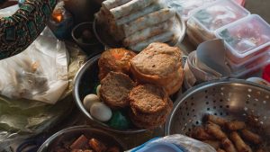A vibrant assortment of Vietnamese street food at a market in Bình Thuận, showcasing traditional snacks.